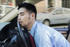 Tired young man sleeping inside the car