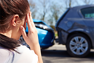 Woman looking at car crash