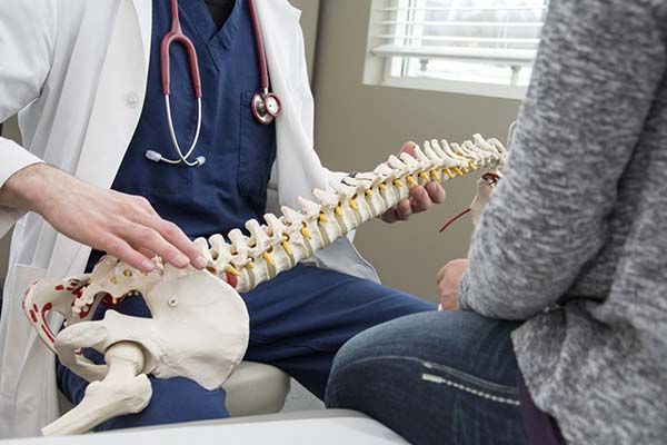 patient learning about the benefits of chiropractic treatment in Richardson