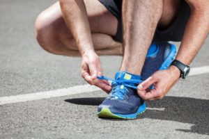 man tying his shoe and having good range of motion