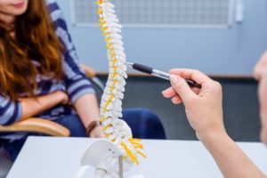 chiropractor talking to a patient about a postural screening