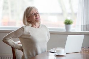woman sitting with a trigger of sciatic nerve pain