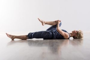 woman stretching to treat sciatica naturally