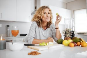 woman eating fruit in the kitchen