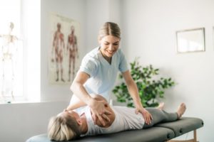 woman treating a patient with holistic chiropractic care