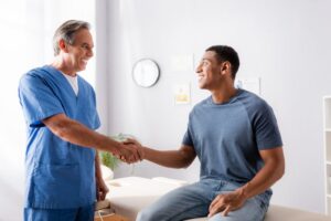 happy patient shaking hands with a chiropractor