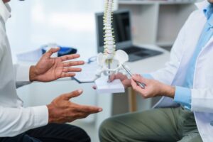 chiropractor and patient talking about sciatica pain