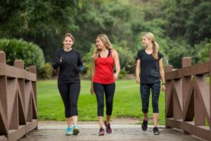 three women walking in exercise clothing