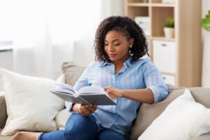 woman sitting on a couch and reading